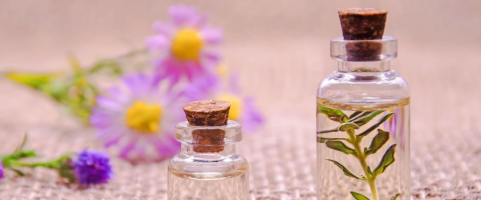article about hair growth table with small coloured bottles of essential oils