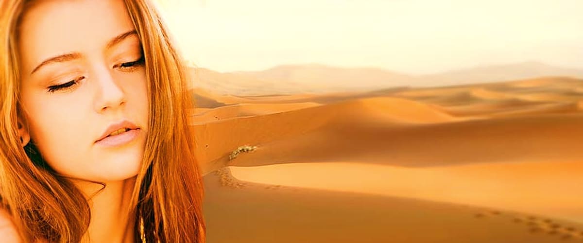 benefits of argan tanning serums woman in front of sand dunes